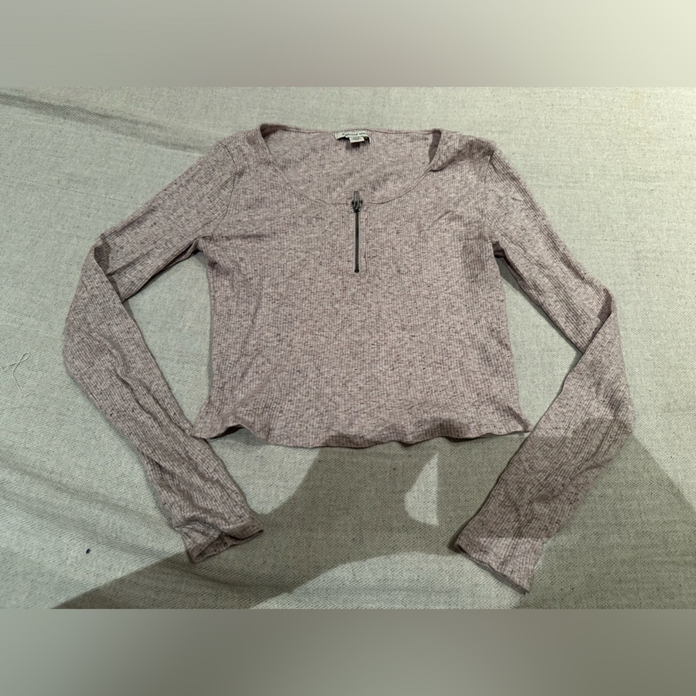 Pink long sleeve shirt with zipper detail by collar